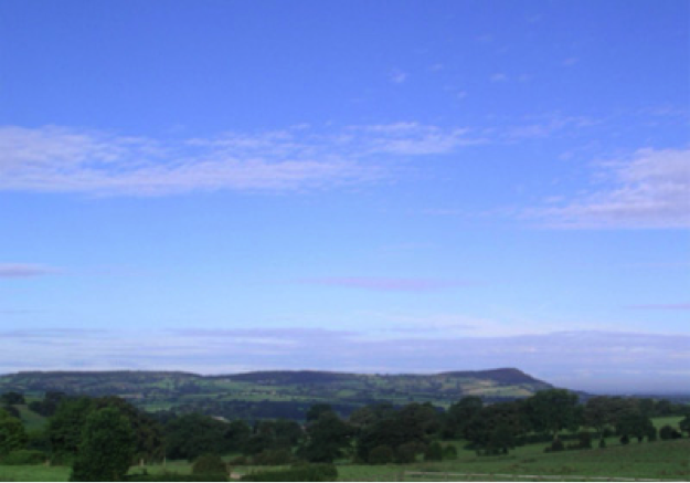 The view west from Toft Hall garden across the Cheshire plain to Wales